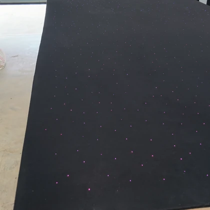 Finished dark roof panel with illuminated purple fibre-optic lights