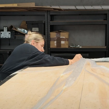 Preparing fibre-optic strands on a roof panel in the workshop